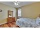 Bedroom with hardwood floors, and a patterned bedspread at 9023 Sienna Moss Ln, Riverview, FL 33578