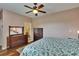 Bedroom with a vanity sink, hardwood floors, and a patterned bedspread at 9023 Sienna Moss Ln, Riverview, FL 33578