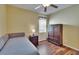 Comfortable bedroom featuring hardwood floors, a window, and dark colored cabinets at 9023 Sienna Moss Ln, Riverview, FL 33578