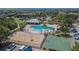 Aerial view showcasing a community pool with a covered pavilion, playground, and basketball court at 9023 Sienna Moss Ln, Riverview, FL 33578