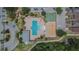 Aerial view of a community pool featuring a splash pad, basketball court, and ample seating at 9023 Sienna Moss Ln, Riverview, FL 33578