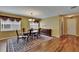 Formal dining room featuring hardwood floors, a chandelier, and natural lighting at 9023 Sienna Moss Ln, Riverview, FL 33578