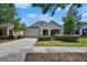 Charming single-story home with attached garage and covered entryway, surrounded by lush landscaping at 9023 Sienna Moss Ln, Riverview, FL 33578