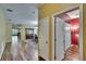 Hallway with hardwood floors leading to dining room and other rooms at 9023 Sienna Moss Ln, Riverview, FL 33578