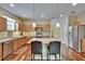 The eat-in kitchen features stainless steel appliances, lots of cabinetry and an island with bar stool seating at 9023 Sienna Moss Ln, Riverview, FL 33578
