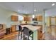 The kitchen has an island with seating and is adjacent to the entry to the house at 9023 Sienna Moss Ln, Riverview, FL 33578