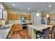 Well-equipped kitchen featuring an island, stainless steel appliances and light wood cabinets at 9023 Sienna Moss Ln, Riverview, FL 33578