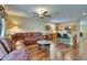 Open-concept living room flows into kitchen, featuring a comfortable leather sofa at 9023 Sienna Moss Ln, Riverview, FL 33578