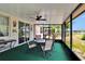 Enjoy the outdoor screened porch featuring a table, chairs, and a ceiling fan for comfort at 9023 Sienna Moss Ln, Riverview, FL 33578