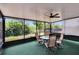 Enjoy this outdoor screened porch featuring a table, chairs, and backyard views at 9023 Sienna Moss Ln, Riverview, FL 33578