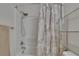 Shower with silver shower head and patterned shower curtain at 9023 Sienna Moss Ln, Riverview, FL 33578
