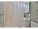 Tiled bathroom featuring a shower-tub combo, white vanity, and updated fixtures at 913 Chester Dr, Clearwater, FL 33756