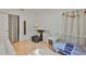 Bright bedroom with white walls, wooden floors, and comfortable furnishings, including crib at 913 Chester Dr, Clearwater, FL 33756