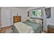 Comfortable bedroom featuring a cozy bed, stylish furnishings, and natural light from windows at 913 Chester Dr, Clearwater, FL 33756