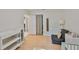 Bright bedroom with wood floors, comfortable chair, white dresser and closet at 913 Chester Dr, Clearwater, FL 33756