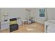 Brightly lit Bedroom with a crib, changing table, side table, and plush chair next to a window at 913 Chester Dr, Clearwater, FL 33756