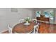 Cozy dining area with a round wooden table, white chairs, and a vintage sideboard, perfect for gatherings at 913 Chester Dr, Clearwater, FL 33756
