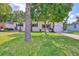 Inviting single-Gathering home with a well-kept lawn, palm trees, and tidy landscaping that adds to its appeal at 913 Chester Dr, Clearwater, FL 33756