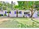 Charming single-story home with a well-manicured lawn and vibrant landscaping, showcasing curb appeal at 913 Chester Dr, Clearwater, FL 33756