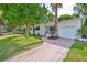 Inviting home featuring a lush lawn and mature trees, plus a driveway leading to an attached garage at 913 Chester Dr, Clearwater, FL 33756