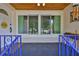 Inviting front porch featuring a tiled floor and covered area, with windows overlooking the yard at 913 Chester Dr, Clearwater, FL 33756