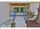 Attractive front porch entrance with vibrant blue railings, stylish decor, and a cozy, welcoming ambiance at 913 Chester Dr, Clearwater, FL 33756