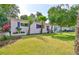Charming single-story home with a well-manicured front yard, palm trees, and lovely landscaping that enhances its curb appeal at 913 Chester Dr, Clearwater, FL 33756