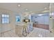 Updated kitchen featuring granite countertops, white cabinetry, stainless steel appliances, and a breakfast bar at 913 Chester Dr, Clearwater, FL 33756