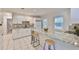 Updated kitchen featuring granite countertops, white cabinetry, stainless steel appliances, and a breakfast bar at 913 Chester Dr, Clearwater, FL 33756