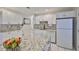 Updated kitchen featuring granite countertops, white cabinetry, stainless steel appliances, and ample storage space at 913 Chester Dr, Clearwater, FL 33756
