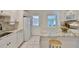 Updated kitchen featuring granite countertops, white cabinetry, stainless steel appliances, and a breakfast bar at 913 Chester Dr, Clearwater, FL 33756
