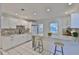 Updated kitchen featuring granite countertops, white cabinetry, stainless steel appliances, and a breakfast bar at 913 Chester Dr, Clearwater, FL 33756