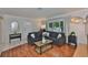 Cozy living area featuring a plush sectional sofa, hardwood floors, and natural light from the window at 913 Chester Dr, Clearwater, FL 33756