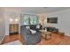 Comfortable living room with hardwood floors, modern decor, and a large sectional sofa perfect for relaxing at 913 Chester Dr, Clearwater, FL 33756