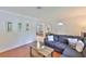 Inviting living room boasts hardwood floors, a sectional sofa, and access to the dining area at 913 Chester Dr, Clearwater, FL 33756