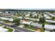 Community aerial view showcasing homes with tidy landscaping, streets, and a serene lake nearby at 9743 36Th N Way # 4, Pinellas Park, FL 33782