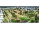 A sprawling aerial shot showcases the golf course, lush greenery, and the residential layout within the community at 9743 36Th N Way # 4, Pinellas Park, FL 33782