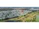 Aerial view of a charming neighborhood with neatly lined houses and a sprawling golf course winding throughout the community at 9743 36Th N Way # 4, Pinellas Park, FL 33782