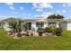 Landscaped backyard featuring tropical plants and an outdoor dining area at 9743 36Th N Way # 4, Pinellas Park, FL 33782