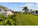 Lush backyard with green grass and tropical plants, offering a serene outdoor space at 9743 36Th N Way # 4, Pinellas Park, FL 33782