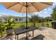 Landscaped backyard with a patio, picnic table, and lush plants, perfect for outdoor living at 9743 36Th N Way # 4, Pinellas Park, FL 33782