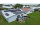 A cozy backyard patio featuring a grill, table, chairs, and solar panels on the roof at 9743 36Th N Way # 4, Pinellas Park, FL 33782