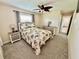 Comfortable bedroom with a floral comforter, ceiling fan, and neutral decor creates a cozy retreat at 9743 36Th N Way # 4, Pinellas Park, FL 33782