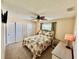 Bright bedroom featuring a floral comforter, ceiling fan, and double closets offers comfort and style at 9743 36Th N Way # 4, Pinellas Park, FL 33782