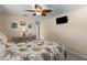Bedroom with tropical bedding, a ceiling fan, a dresser, and wall-mounted TV at 9743 36Th N Way # 4, Pinellas Park, FL 33782