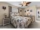 Bedroom featuring a decorative ceiling fan, tropical bedding, and neutral walls at 9743 36Th N Way # 4, Pinellas Park, FL 33782