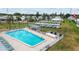 The aerial photograph highlights the sparkling community pool, ample seating, and well-maintained surrounding grounds at 9743 36Th N Way # 4, Pinellas Park, FL 33782