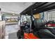 Organized garage with a golf cart, storage shelves, and well-lit workspace at 9743 36Th N Way # 4, Pinellas Park, FL 33782