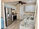 Modern kitchen with stainless steel appliances, granite countertops, white cabinets, and ample storage space at 9743 36Th N Way # 4, Pinellas Park, FL 33782