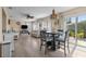 Bright living room with wood floors, a ceiling fan, and sliding glass doors to a patio at 9743 36Th N Way # 4, Pinellas Park, FL 33782